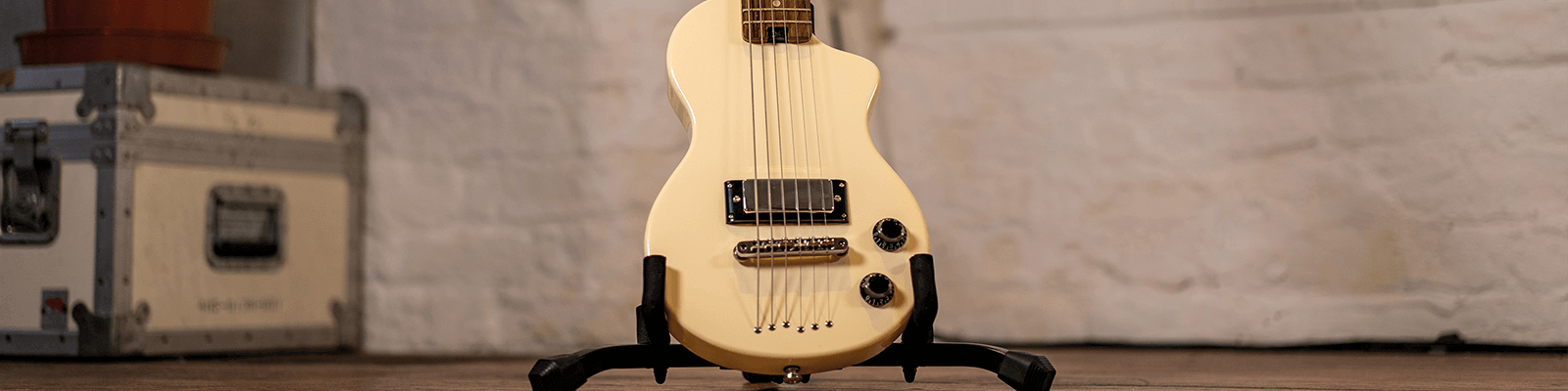 banner image of the white carry-on guitar on stand