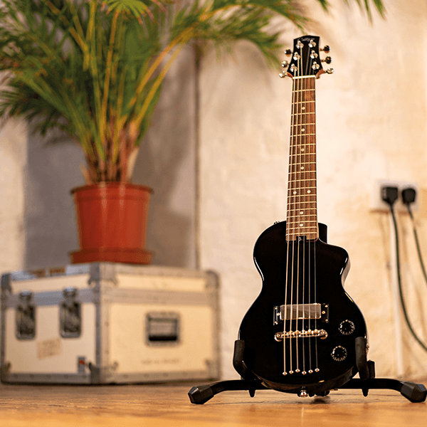image of the black Carry-On Mini Guitar on a stand
