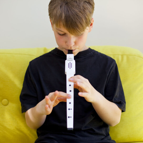 child playing the white Small Digital Wind Musical Instrument